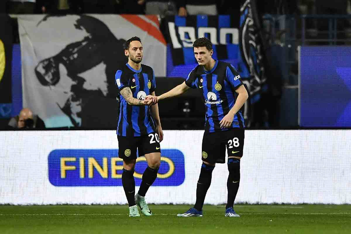 Benjamin Pavard con la maglia dell'Inter dà la mano a Calhanoglu
